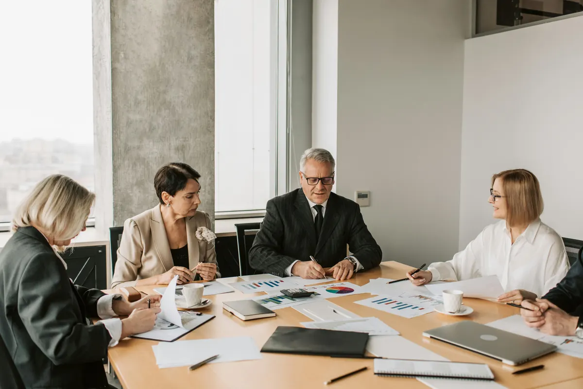 Business meeting table with documents and laptops